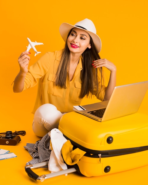 Mujer sonriente jugando con estatuilla de avión