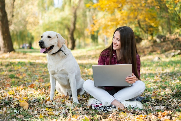 Mujer sonriente mirando a su perro