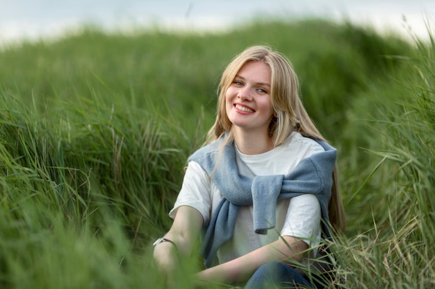 Mujer sonriente posando en pasto