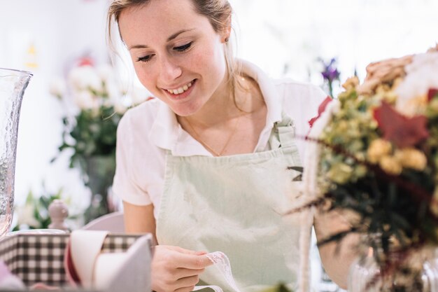 Mujer sonriente que elige cintas para el ramo