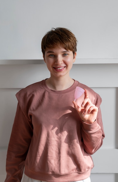 Mujer sonriente de tiro medio con copa menstrual