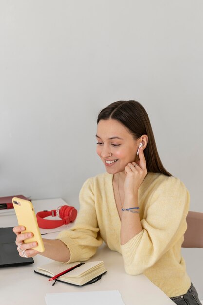 Mujer sonriente de tiro medio con teléfono