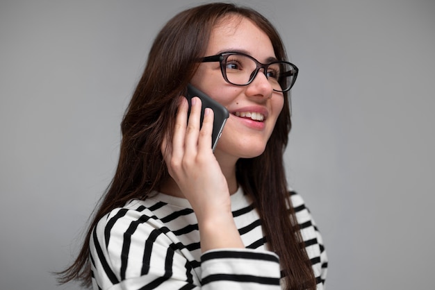 Foto gratuita mujer sonriente de vista lateral hablando por teléfono