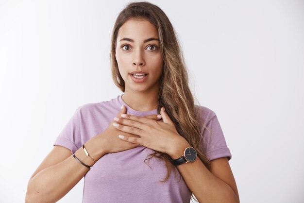 Mujer sorprendida preocupada presione las palmas de las manos contra su pecho