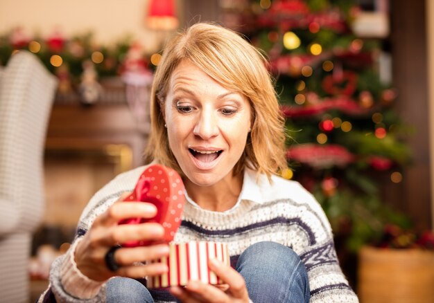 Mujer sorprendida con un regalo de navidad