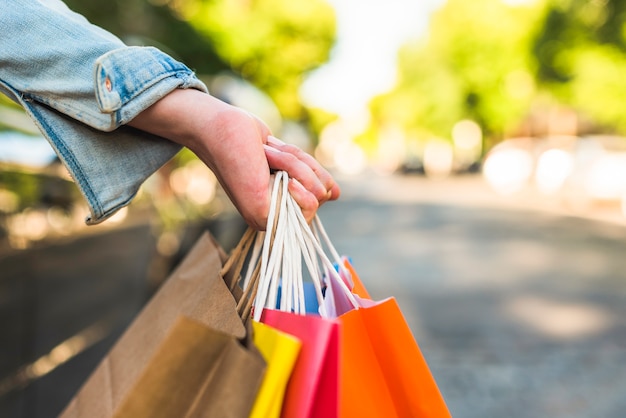 Foto gratuita mujer sosteniendo bolsas de compras en la mano