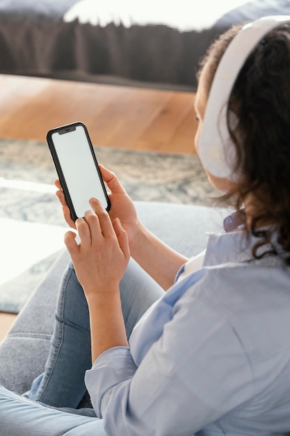 Foto gratuita mujer sosteniendo smartphone de cerca