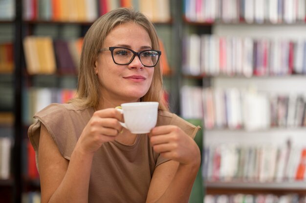 Mujer sosteniendo una taza de tiro medio