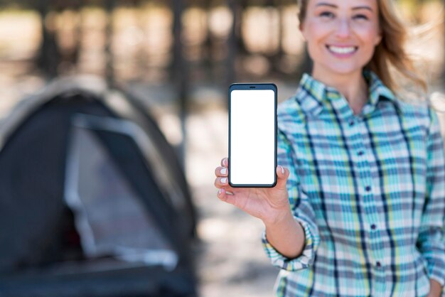 Mujer sosteniendo teléfono móvil de espacio de copia vertical