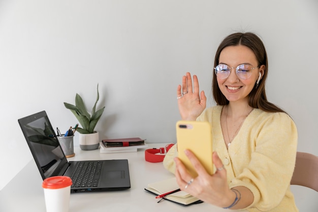 Mujer sosteniendo un teléfono de tiro medio