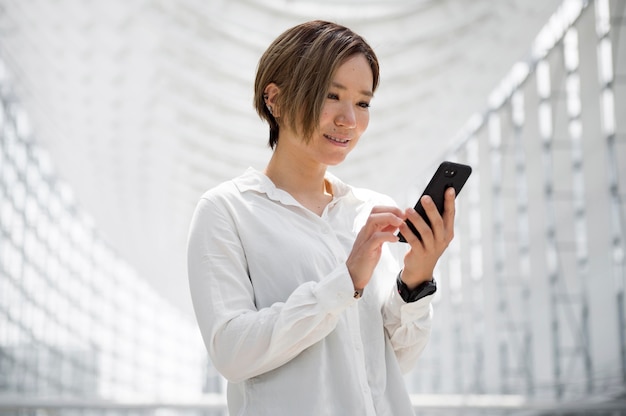 Mujer sosteniendo un teléfono de tiro medio