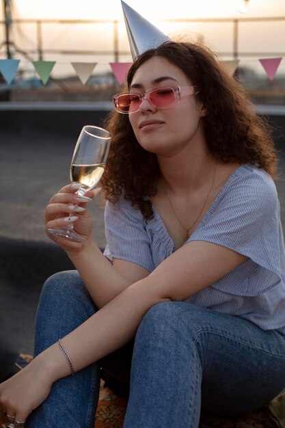 Mujer sosteniendo un vaso de tiro medio