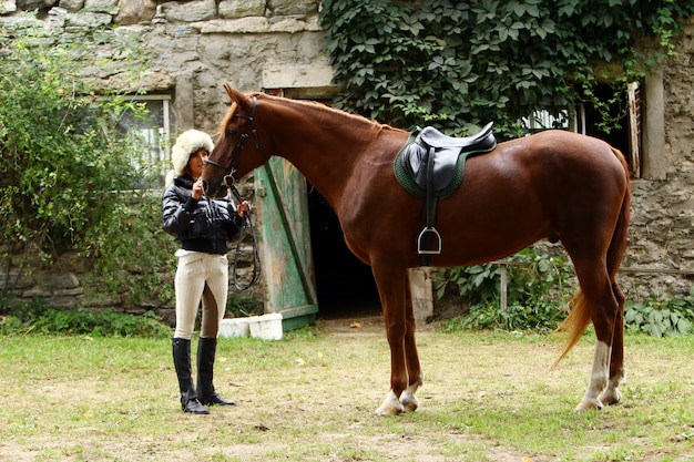 Mujer y su caballo marrón