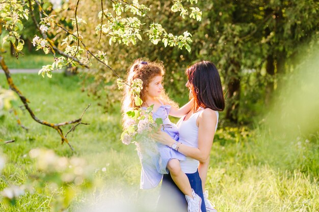 Mujer con su hija sosteniendo flores