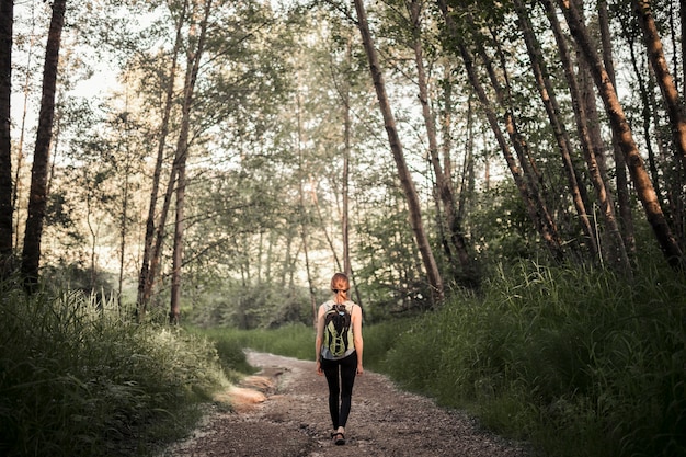 Foto gratuita mujer con su mochila de senderismo en el bosque