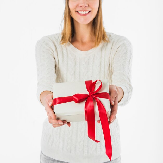 Mujer en suéter ligero con pequeña caja de regalo