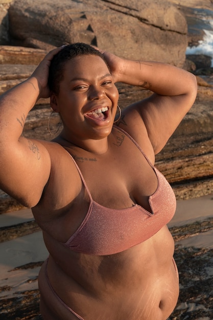 Una mujer de talla mediana posando en la orilla del mar