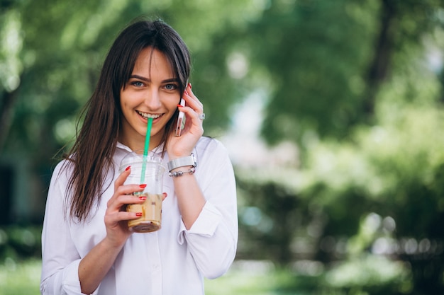 Mujer con teléfono y café