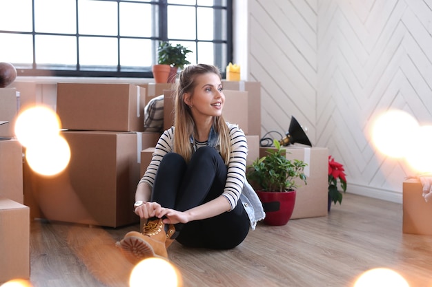 Foto gratuita mujer terminó con paquetes de carga y está sentada junto a las cajas en el piso