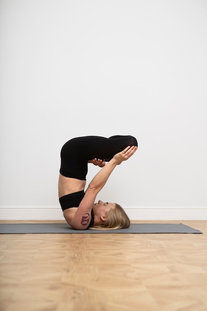 Mujer de tiro completo haciendo yoga