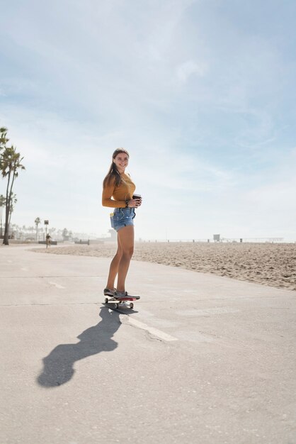 Mujer de tiro completo en patineta