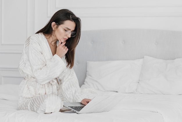 Foto gratuita mujer de tiro completo que trabaja en la cama