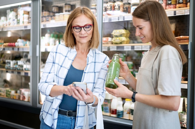 Mujer de tiro medio comprobando producto