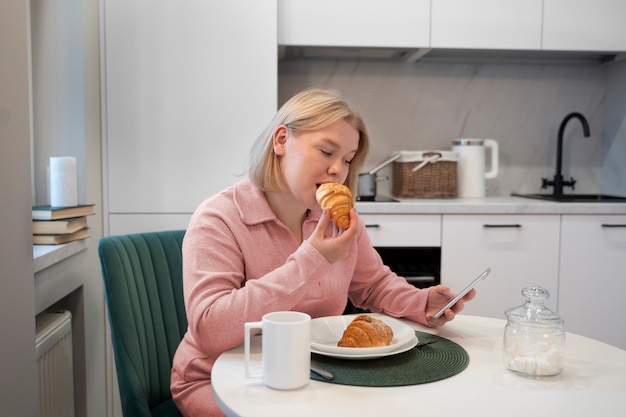 Mujer de tiro medio desayunando