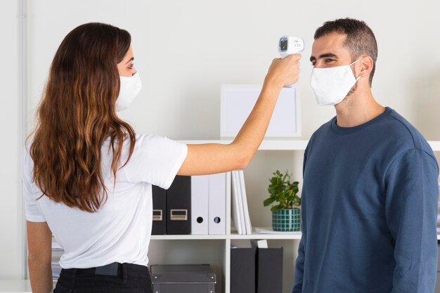 Mujer de tiro medio con dispositivo de temperatura