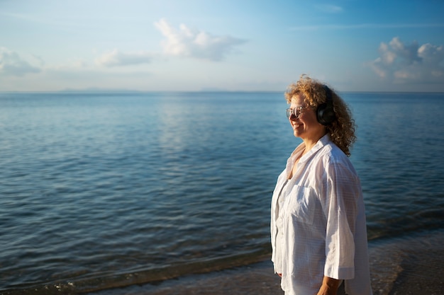 Foto gratuita mujer de tiro medio pasando un día sola en la playa.