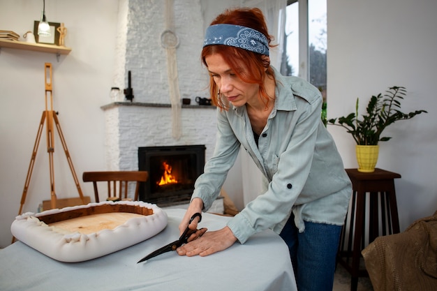 Mujer de tiro medio restaurando muebles.