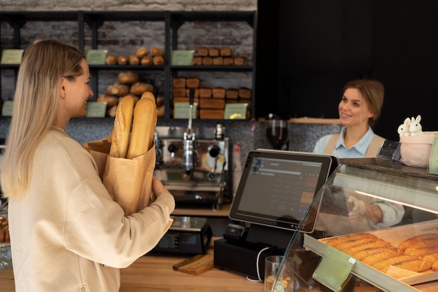 Mujer de tiro medio trabajando en panadería