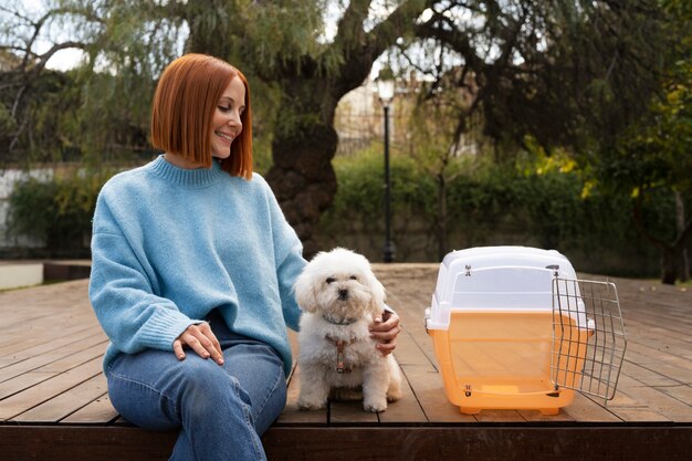 Mujer de tiro medio con transportador de mascotas.