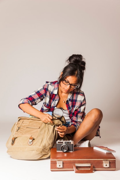 Mujer turista con bolsa y lupa