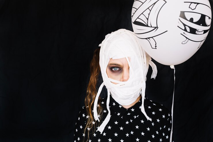 Foto gratuito mujer con vendajes y globo de momia