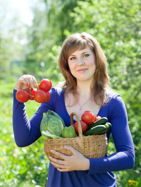 Mujer con verduras cosecha en el jardín