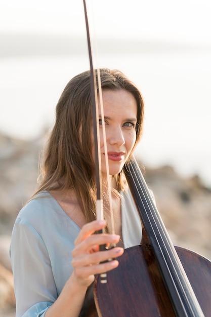 Foto gratuita mujer con violonchelo y arco