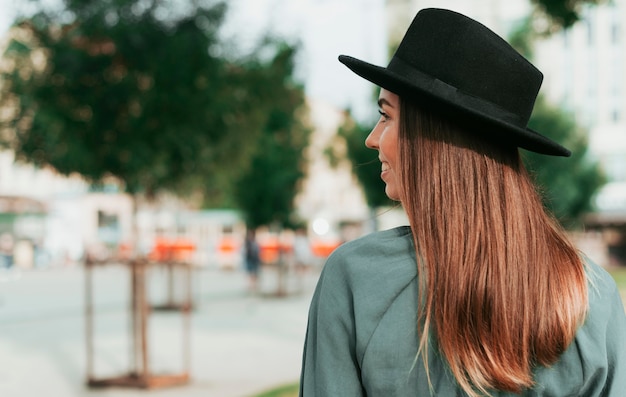 Foto gratuita mujer de vista lateral con un sombrero negro con espacio de copia