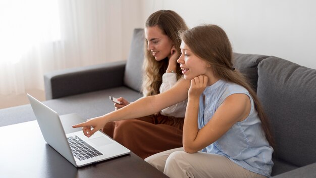 Mujeres adultas comprando online juntas en casa