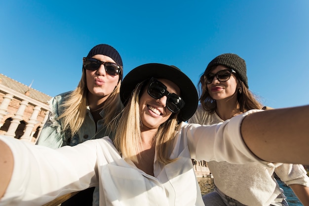 Mujeres alegres que toman selfie durante el viaje
