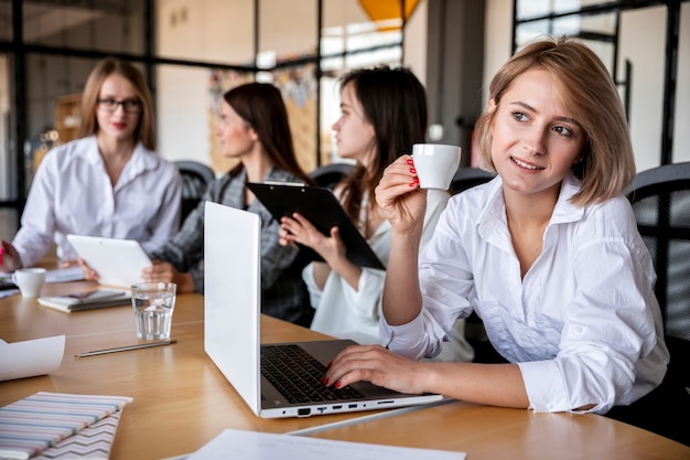 Mujeres de alto ángulo trabajando y tomando café