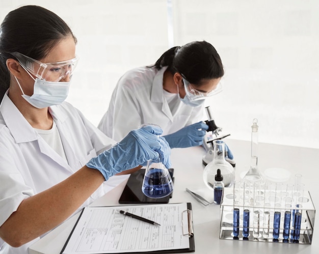 Mujeres asiáticas trabajando juntas en un proyecto químico