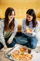 Foto gratuita mujeres jóvenes con fiesta de pizza
