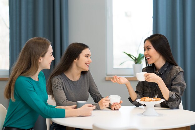 Mujeres jóvenes positivas que trabajan desde casa