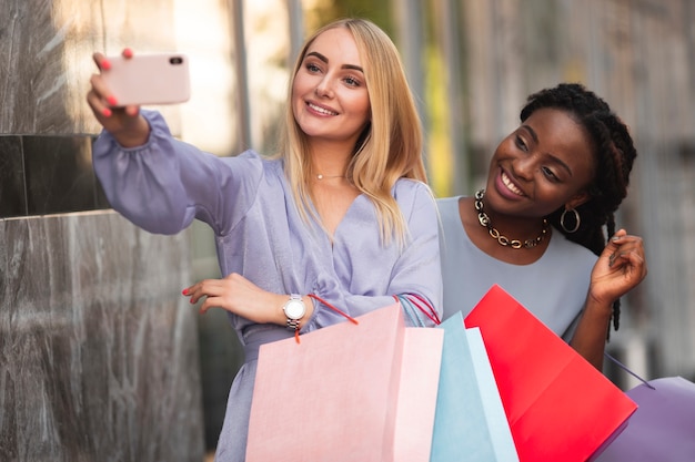 Foto gratuita mujeres con maquetas de bolsas de compras