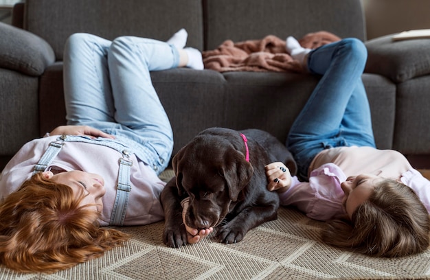 Foto gratuita mujeres y perro tendido en el piso