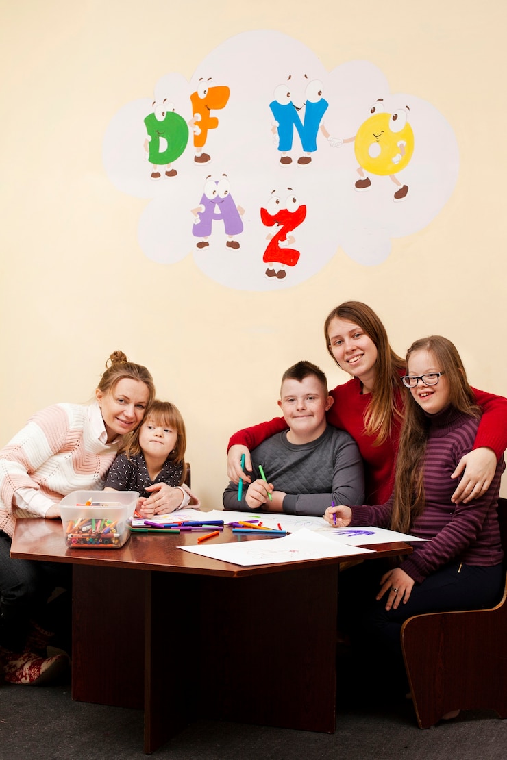 Foto gratuito mujeres posando con niños con síndrome de down
