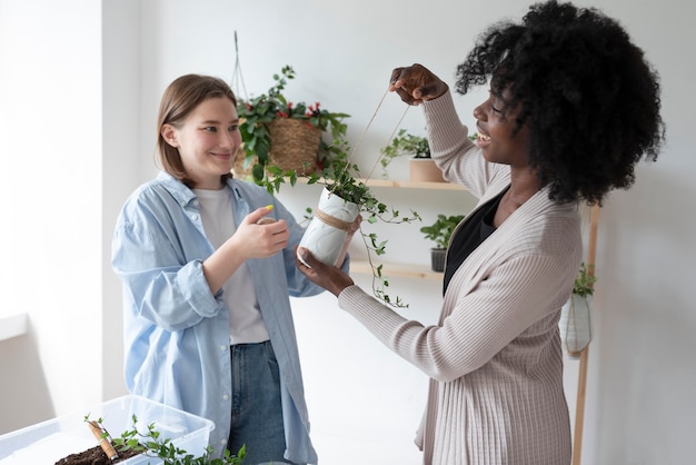 Mujeres que tienen un jardín sostenible en el interior.