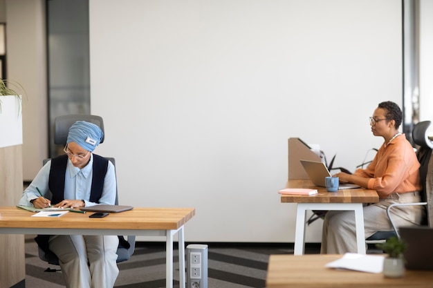 Mujeres que trabajan en el escritorio para el trabajo de oficina