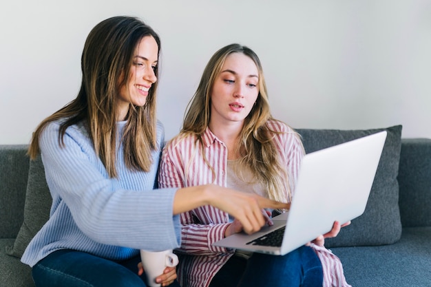 Mujeres que usan la computadora portátil junto